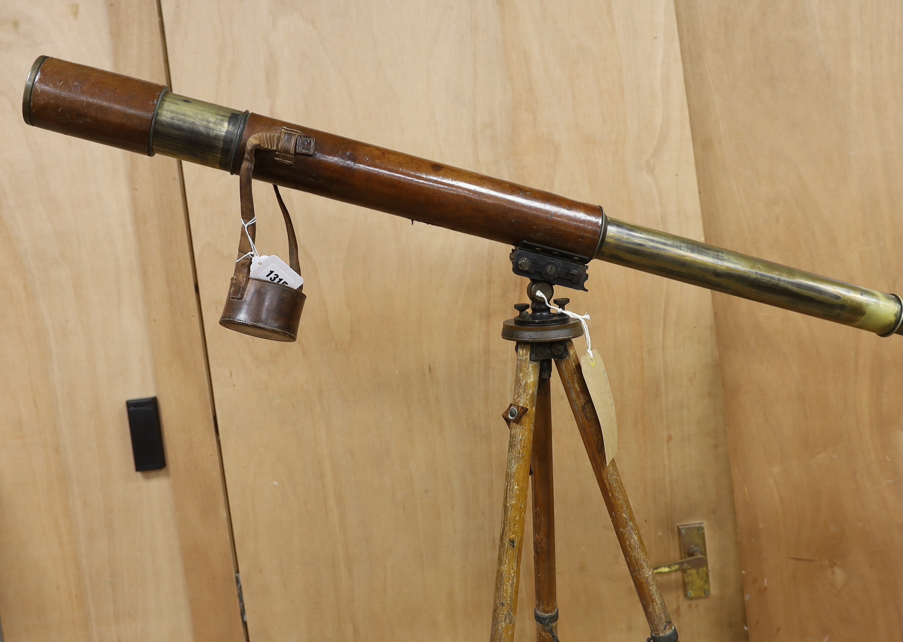A WWI leather cased telescope and tripod, 57cm
